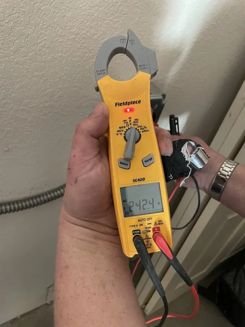 Voltage testing with clamp meter during Outlet Installation in Breckenridge